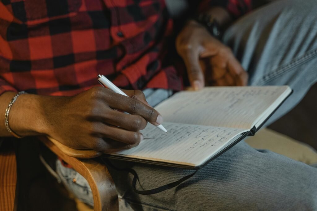 person writing journal reflection